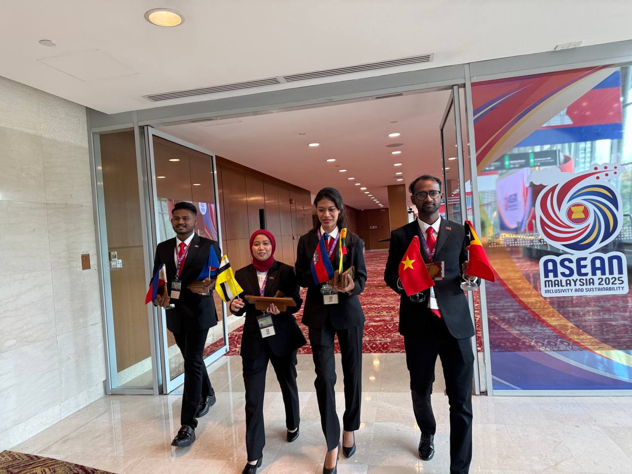 YSS delegates carrying ASEAN member country flags at ASEAN Summit Malaysia 2025