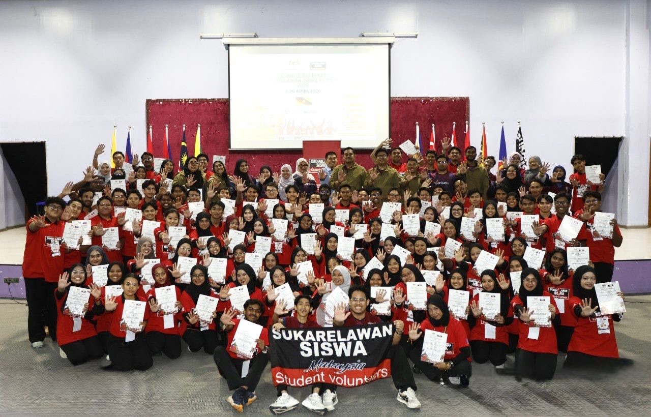 YSS student volunteers in red mission shirts holding their certificates at a cohort graduation